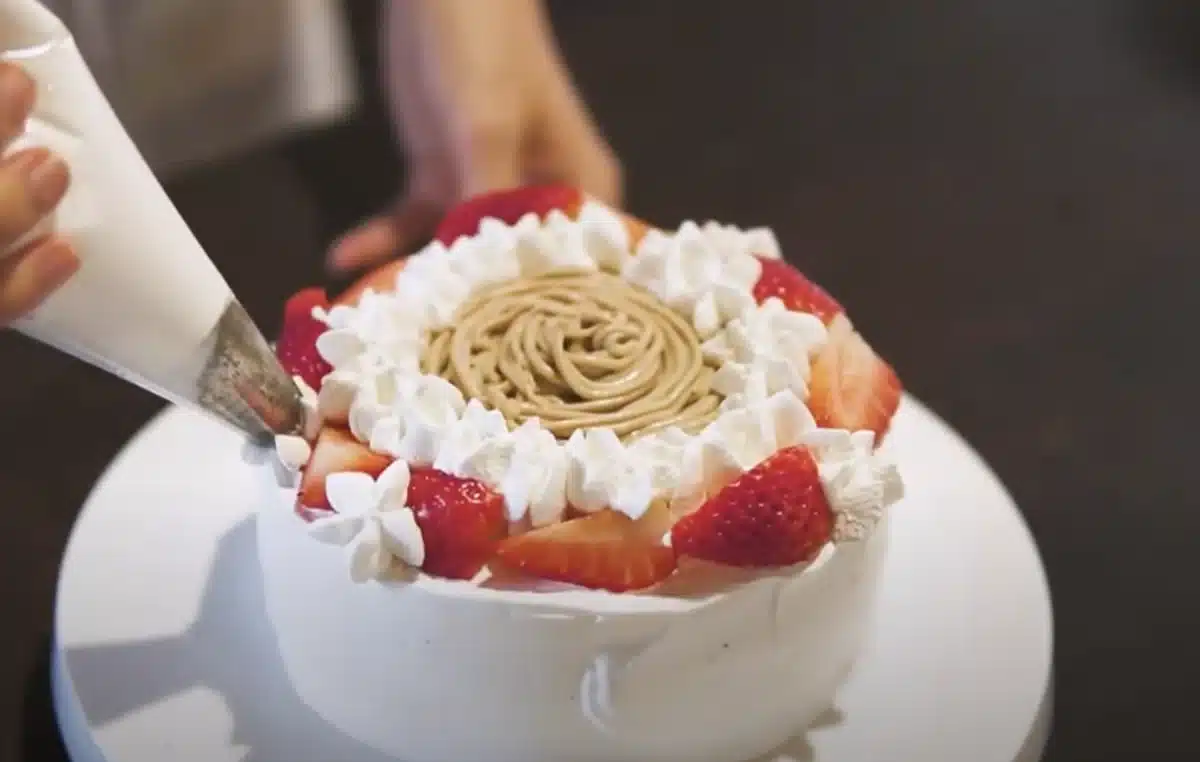 乳不使用で作るふわっふわのホイップクリーム ケーキに生クリームを絞っている